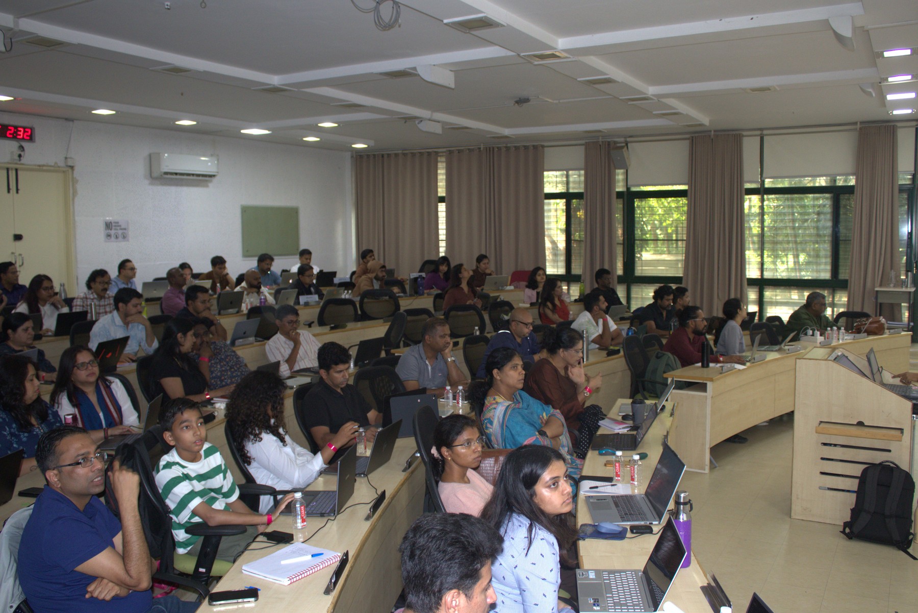 A packed room of working professionals and leaders